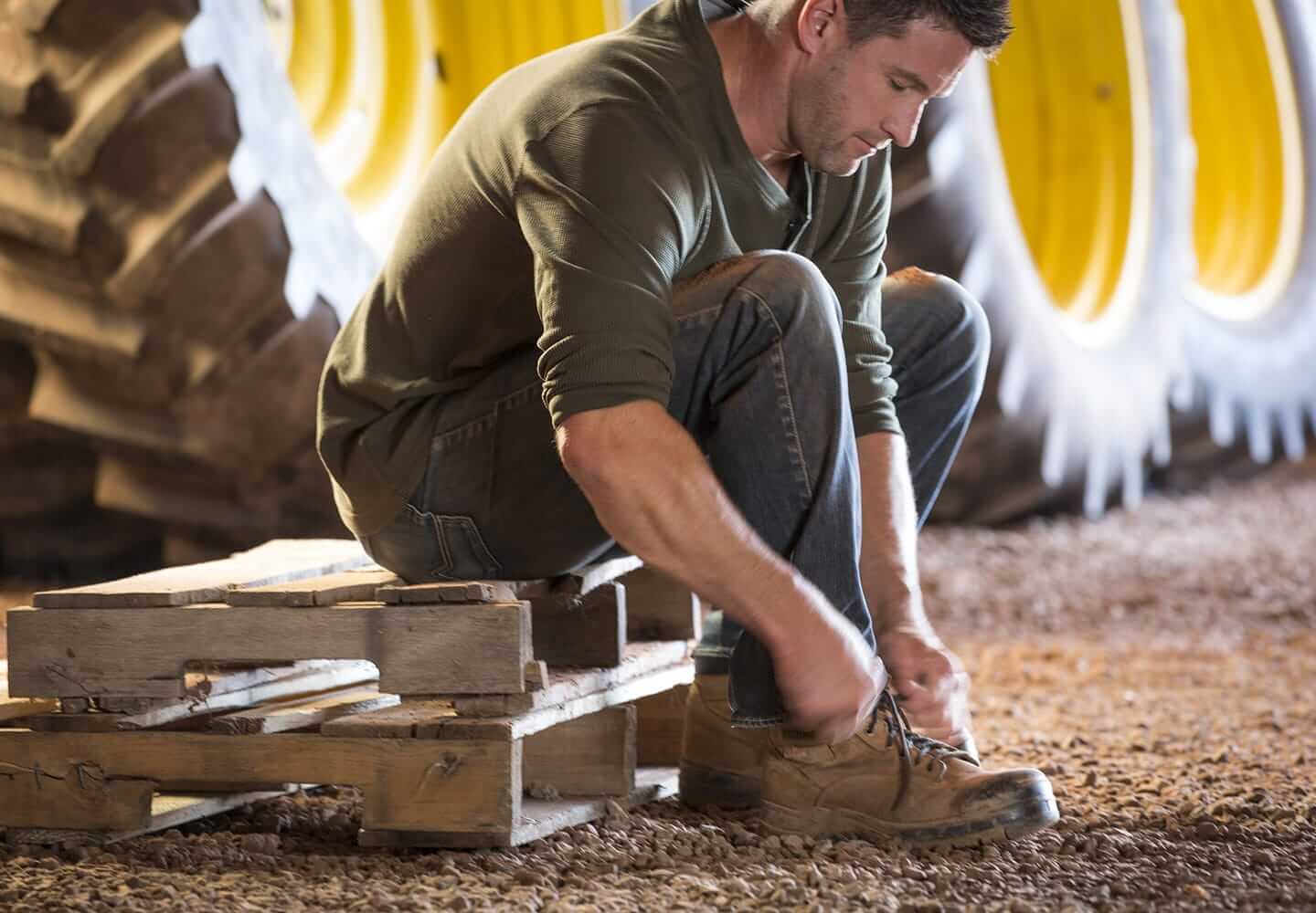 CavAgri Farmer tying shoes